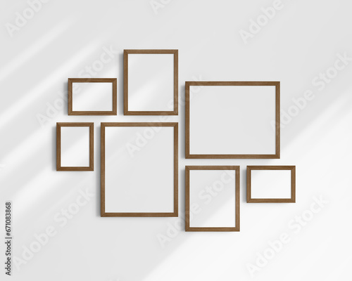 Fototapeta Naklejka Na Ścianę i Meble -  Gallery wall mockup set, 7 brown walnut wood frames. Modern frame mockup. Horizontal, vertical frames, 5x7 (5:7), 7x5 (7:5), 8x10 (4:5), 12x15 (4:5), 15x12 (5:4) inches. White wall with shadows.