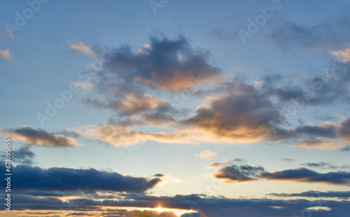 Beautiful sky background - Sunset Sunrise sky with light clouds and real sun. © Anatoliy