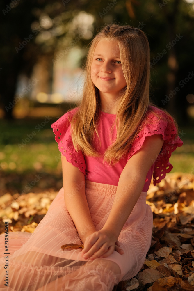 A happy girl enjoying in the autumn park. A happy girl enjoying in the autumn park.