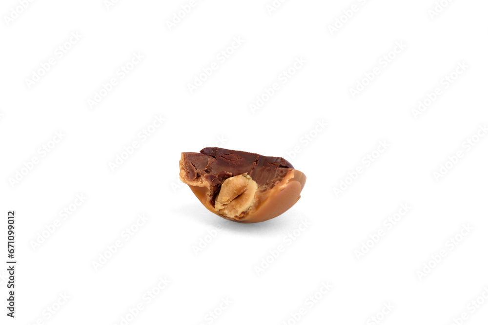 Bitten caramel candy with hazelnut and chocolate isolated on white background. Bitten caramel candy with hazelnut and chocolate isolated on white background.