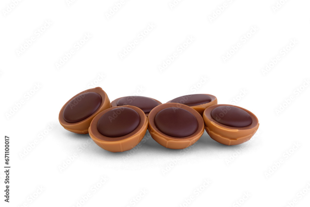 Pile of caramel candies with hazelnut and chocolate isolated on white background.