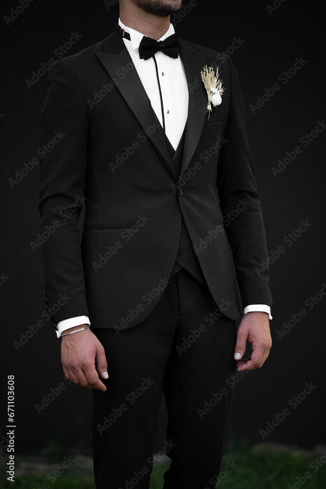 Handsome confident businessman wearing suit isolated on black background black backraund