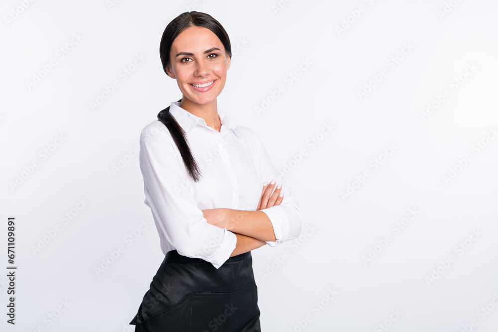 Photo portrait of smiling woman in white shirt crossed hands isolated white color background with copyspace Photo portrait of smiling woman in white shirt crossed hands isolated white color background with copyspace