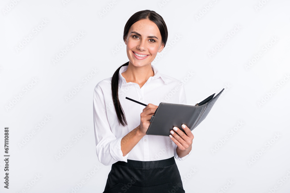 Photo portrait of smiling woman writing down order in cafe isolated on white color background Photo portrait of smiling woman writing down order in cafe isolated on white color background