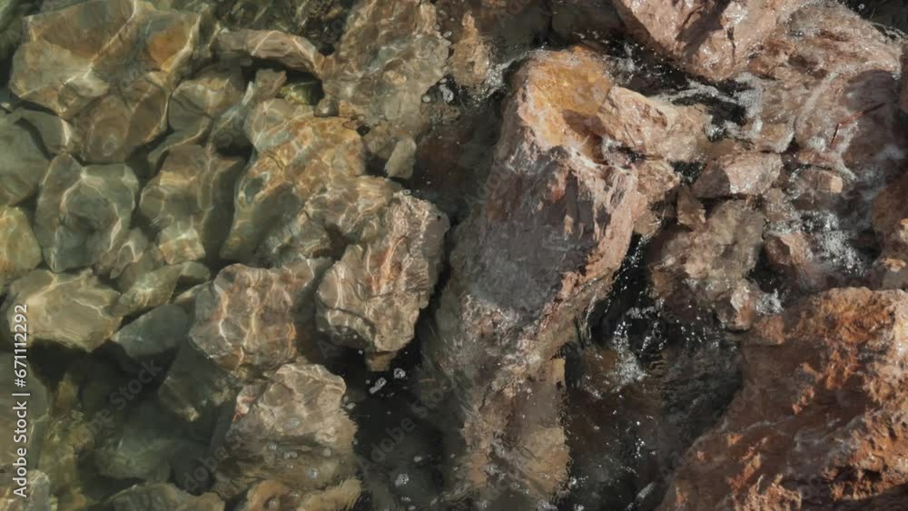The sea water beats against the rocks. The sea water beats against the rocks.
