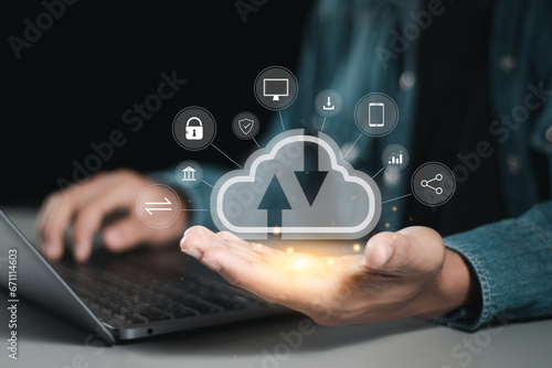 Businessman use laptop and holding cloud computing icon network for cloud storage network technology and large network of backup data platforms, Cloud data transfer and online data storage.