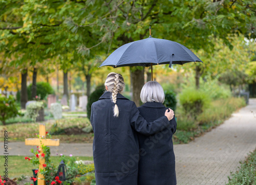 Wallpaper Mural Rear view of daughter holding her mother on the way to the man's grave Torontodigital.ca