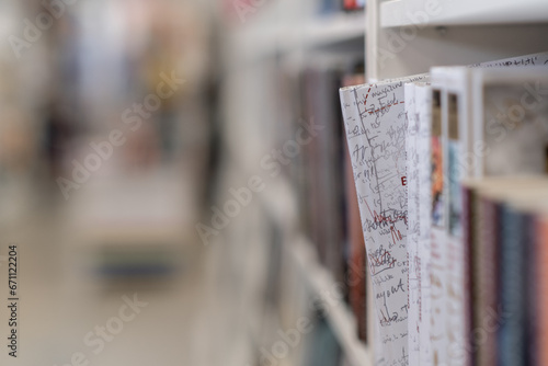 19.10.2023, Novosibirsk, Russia. Bookstore with full shelves of various books. Rows of different colorful books lying on the shelves in the modern urban bookshop. Background from books