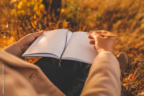 Girl with paper planner outdoors, autumn concept