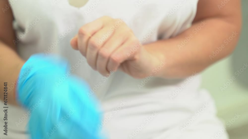 A female doctor or nurse surgeon prepares for a surgical operation and puts on gloves in a clinic or hospital office. Close-up. A female doctor or nurse surgeon prepares for a surgical operation and puts on gloves in a clinic or hospital office. Close-up.