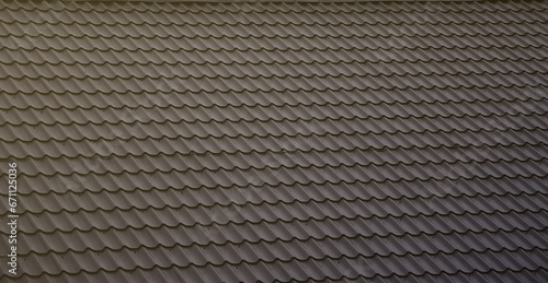 The texture of the roof of painted metal. Close-up detailed view of roof covering for pitched roof. High quality roofing