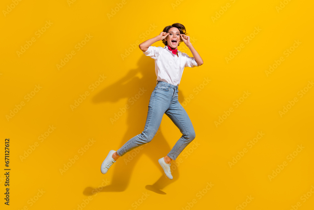 Full length photo of cheerful funky girl wear stylish clothes rejoicing having fun isolated on yellow color background