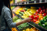 Close up of woman pick up from vegetables on shelf in background of supermarket. Lifestyle concept of vacation or shopping.