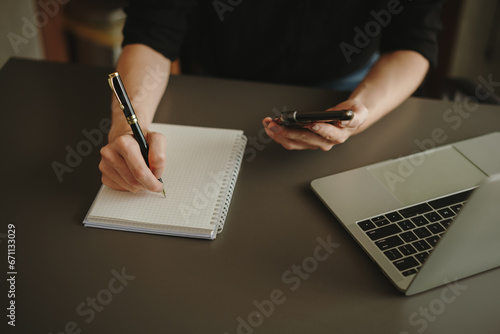person writing on a notebook