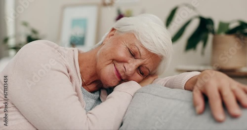 Smile, sleeping and a senior woman on the sofa to relax in retirement whille tired. Happy, calm and an elderly person on the living room couch for a nap, comfort and a dream in the lounge of a home photo