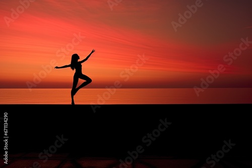 Woman practicing yoga on a concrete platform with a serene sea backdrop