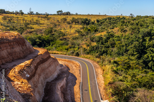 Curve of the road in Serra de Avencas, with the sandstone wall on one side and the vegetation on the other side in the interior of the state of São Paulo, Brazil. photo