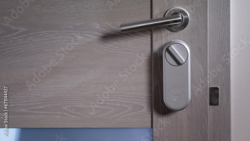 Electric lock on the door. Door and security and control system. Electronic and remotely controlled key. A person passes through a control point. Door handle and smart lock. 