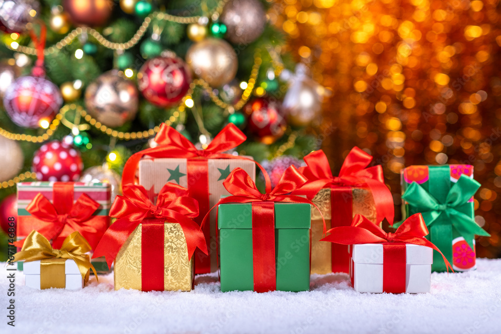 box with gifts and bows on the background of a Christmas tree