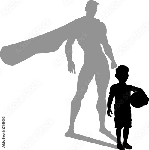 A superhero child or kid boy revealed by his shadow silhouette as a super hero in a cape.