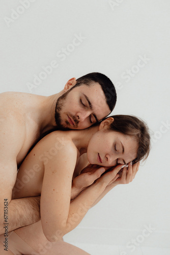 Cheerful woman and man standing on white background. Body positive young couple of lovers. No focus blurred and noise effect