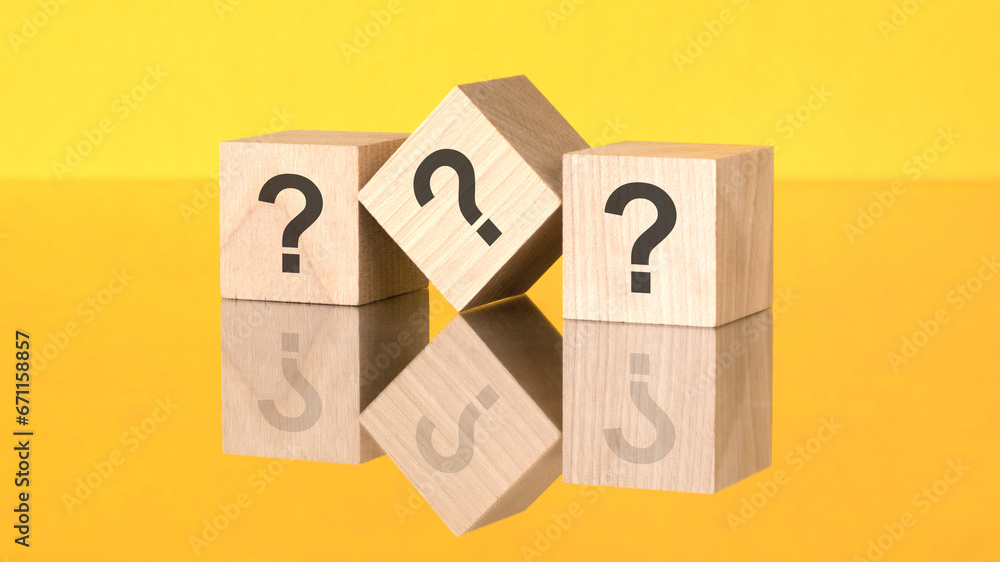 three wooden blocks with questions mark on yellow background. reflection of an image on a glass surface concept three wooden blocks with questions mark on yellow background. reflection of an image on a glass surface concept