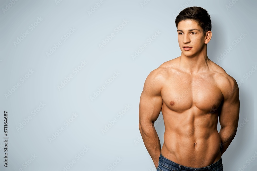Portrait of happy young man bodybuilder posing
