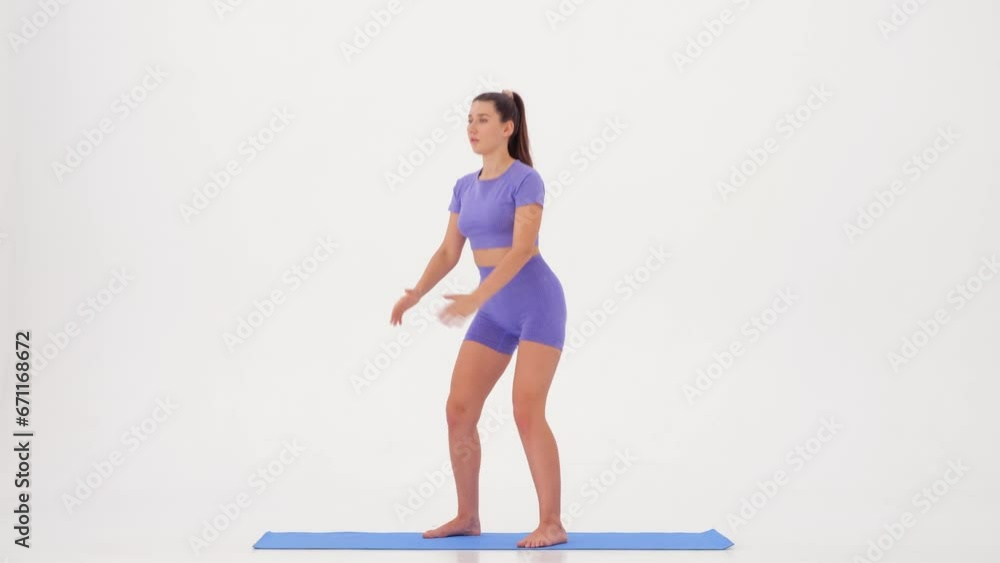 Fitness workout. Sporty Woman doing Exercising on a white background slow motion Fitness workout. Sporty Woman doing Exercising on a white background slow motion