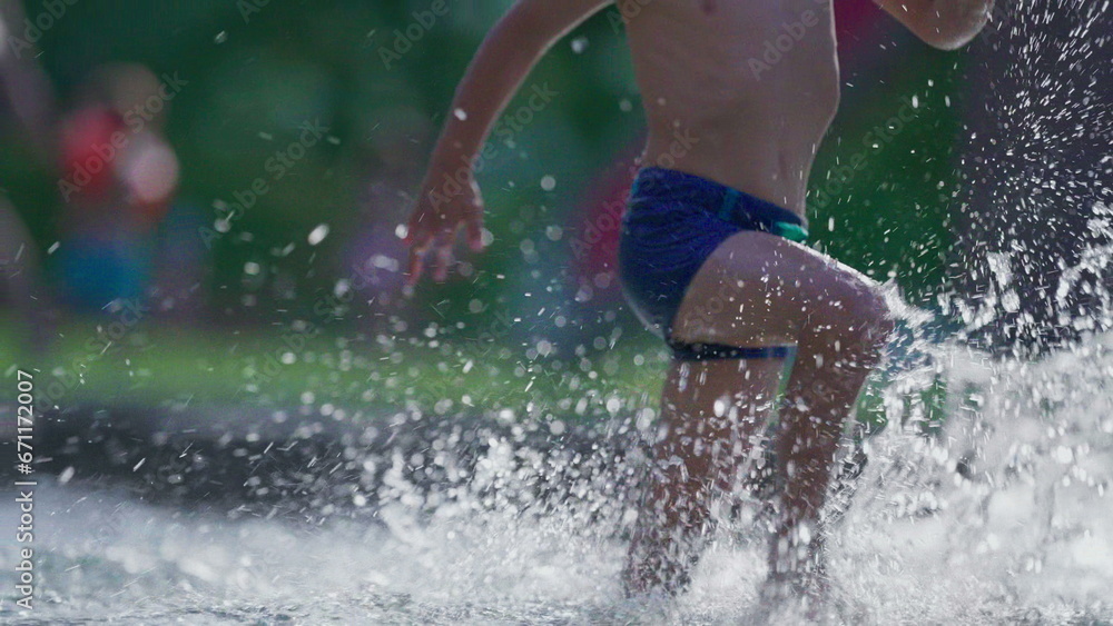 Happy child running in swimming pool water in slow-motion during summer day. Active little boy splashing water runs forward in 120fps Happy child running in swimming pool water in slow-motion during summer day. Active little boy splashing water runs forward in 120fps