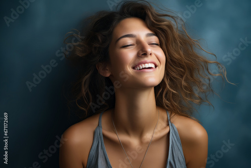 Woman with her eyes closed and her hair blowing in the wind.