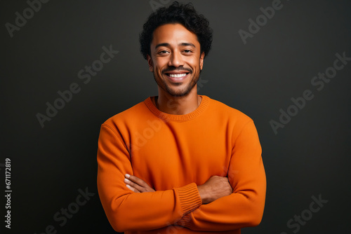Man with smile on his face and arms crossed.