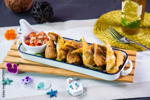 Spicy Fish Crispy Roll with sauce and tomato served in dish tray isolated i napkin side view of japanese seafood fasfood on table photo