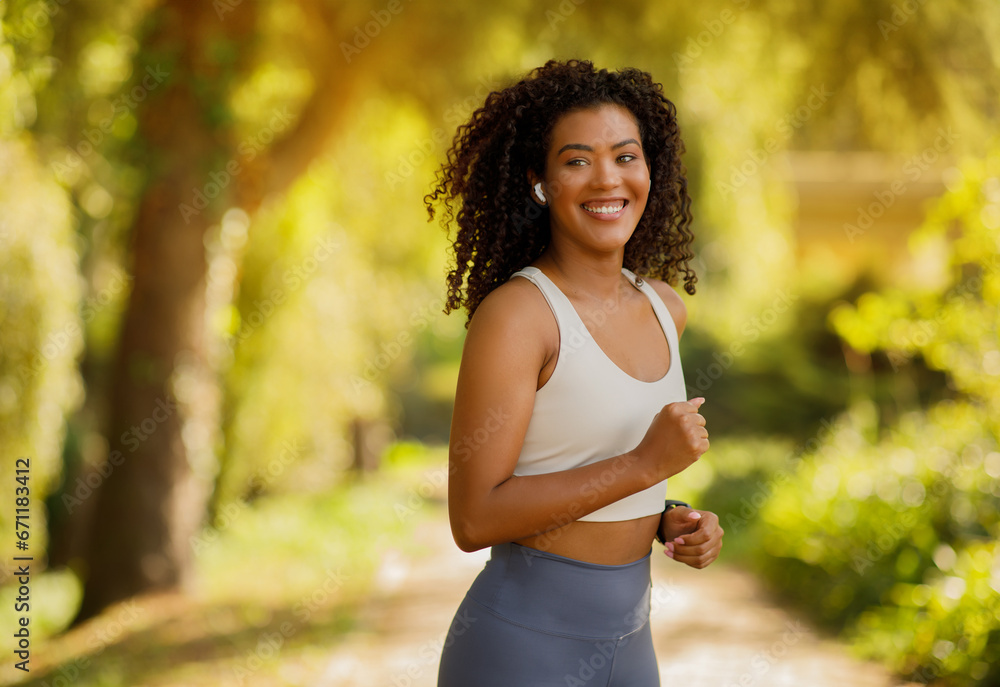 Athletic brazilian lady in sportswear exercising in sunny park Athletic brazilian lady in sportswear exercising in sunny park
