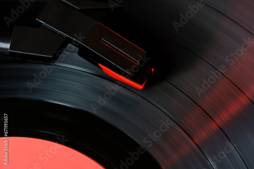 Black vinyl record and needle for playing music from vinyl top view.