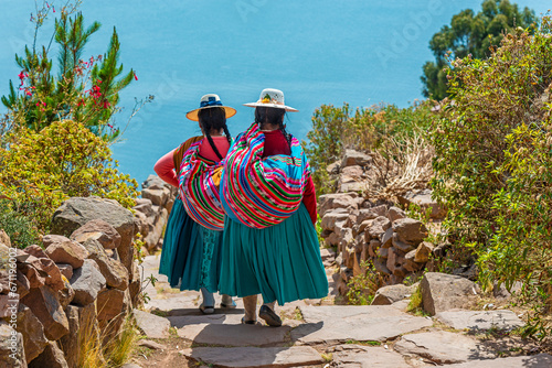 Peruvian indigenous Quechua women in traditional clothes on Taquile Island, Titicaca Lake, Peru. photo
