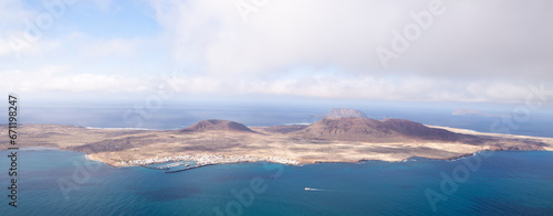 Panoramic of La Graciosa Island and Clear mountain island seen from the river viewpoint. Lanzarote. Canary Islands. Spain