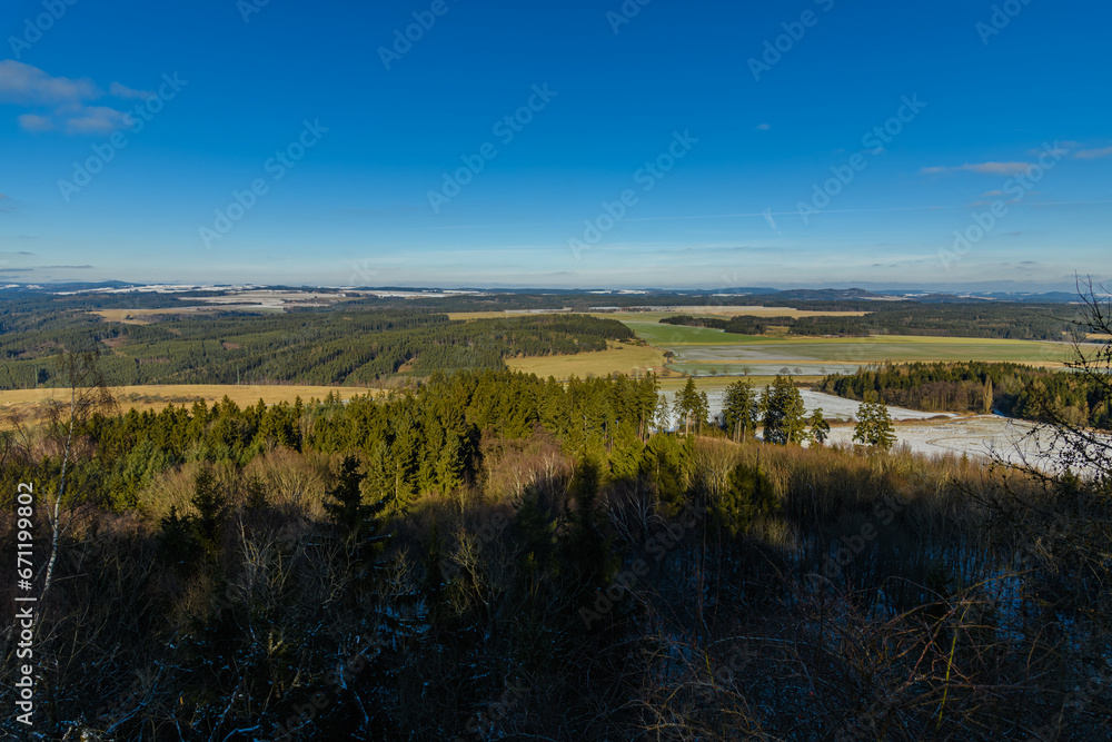 view from a hill into foresty landscape