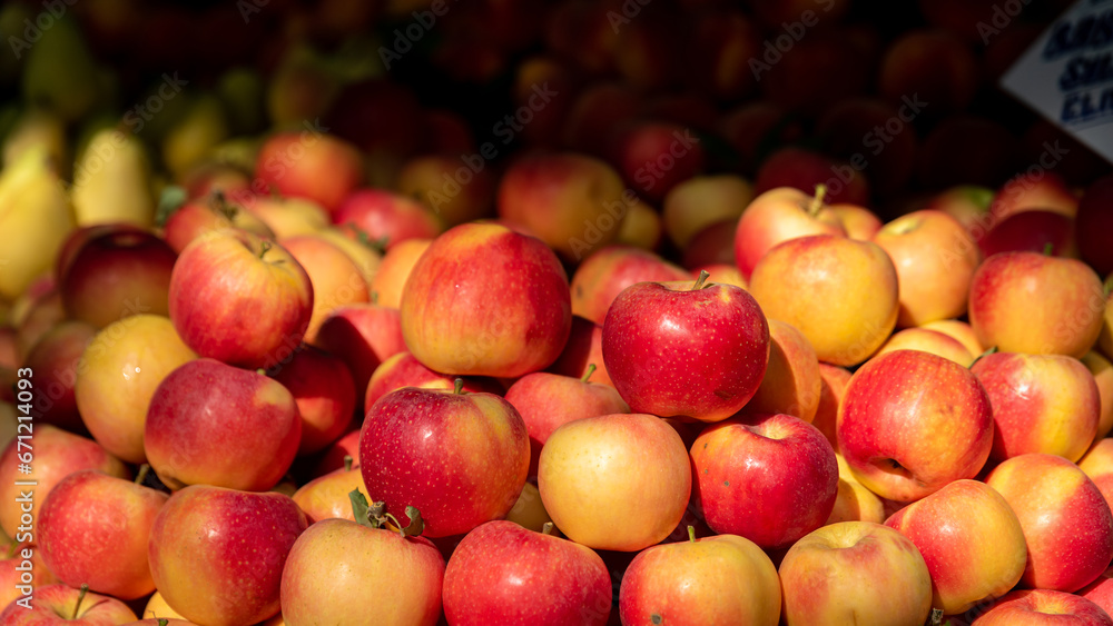 a bunch of apples , background of red apples , fruit in dramatic light a bunch of apples , background of red apples , fruit in dramatic light