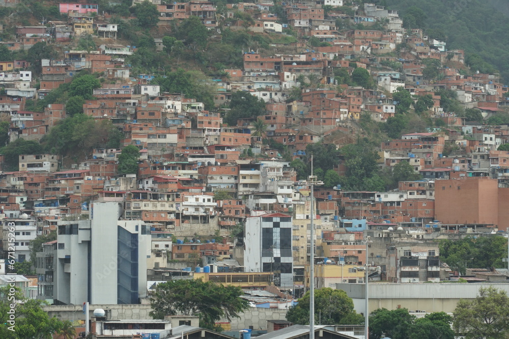 Suburb of La Guaira town near Caracas with poor family houses  showing poverty and is situated on hill near commercial merchant port. View from container terminal.