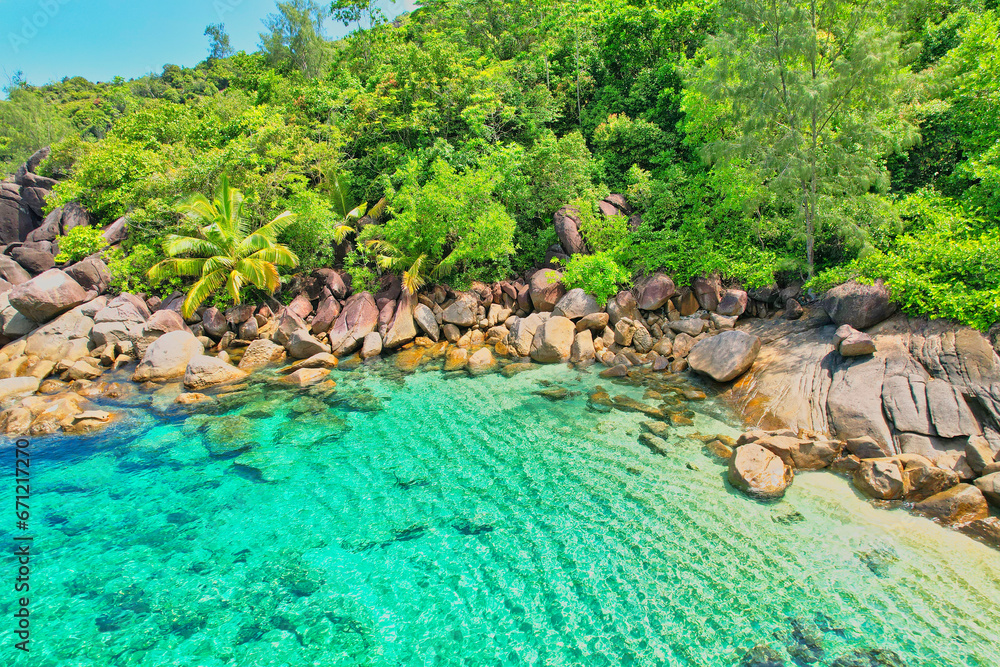 Naklejka premium Drone shot of Anse Major beach, transparent sea, lush forest and granite stones, Mahe, Seychelles 1