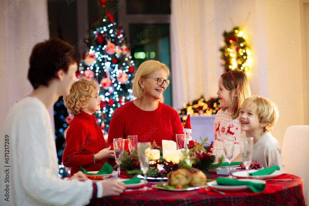 Christmas dinner. Family with kids at Xmas tree. Christmas dinner. Family with kids at Xmas tree.