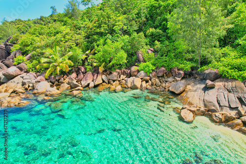 Drone shot of Anse Major beach, transparent sea, lush forest and granite stones, Mahe, Seychelles 1