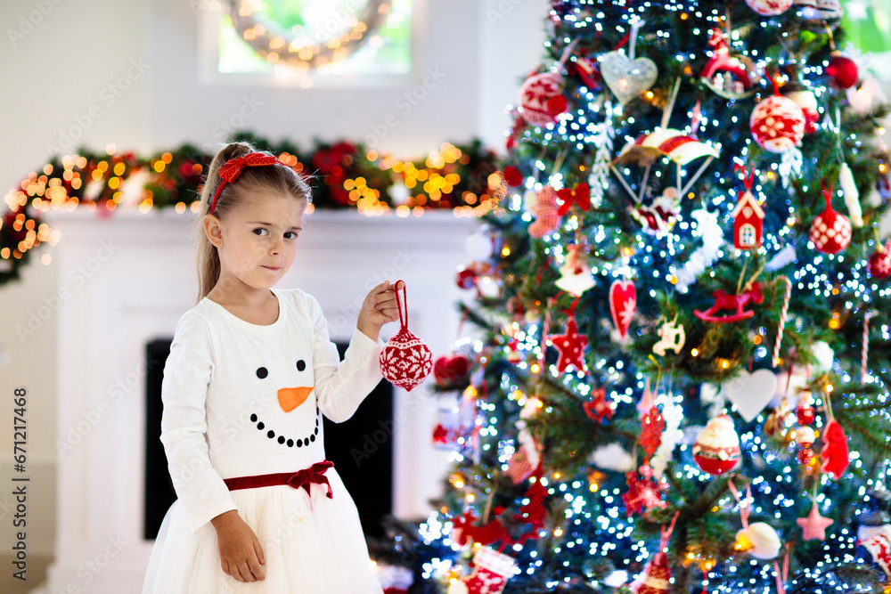 Little girl opening Christmas presents at fire place Little girl opening Christmas presents at fire place