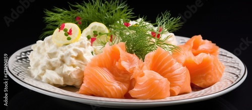 A plate with salted salmon and dill has boiled cauliflower on it