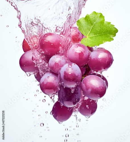 Grapes in a splash of red wine or juice. Advertising photos isolate on white background 