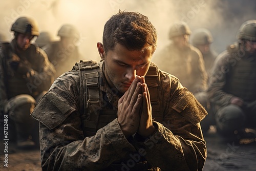 Soldiers pray to God on knees. photo