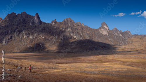 Lonely peruvian peasant lost in a big landscape on the hight lands rocky ambient, dry season, blue skay photo