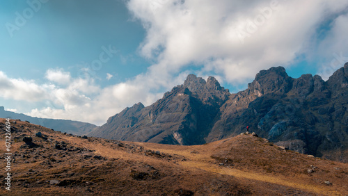 Man standing on a big mountain, waving, in the highlands, cloudy day