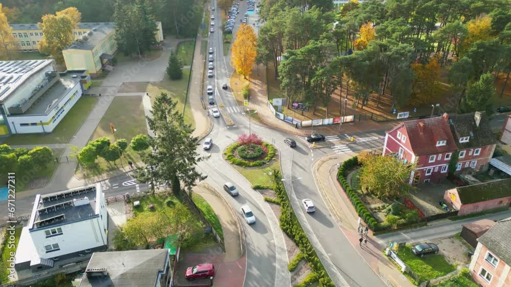 traffic in the city on beautiful autumn sunny evening, cars going on a roundabout, aerial view traffic in the city on beautiful autumn sunny evening, cars going on a roundabout, aerial view