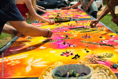 : Hands removing leaves and flowers after the fabric paint had dried, Mahe Seychelles 4